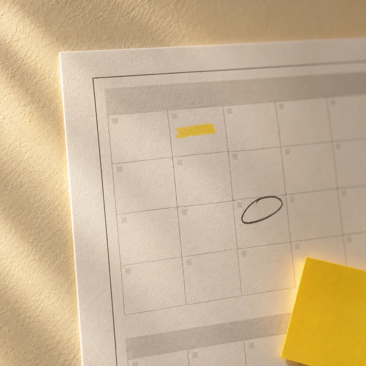 Mini wall calendar with handwritten notes and a circled date